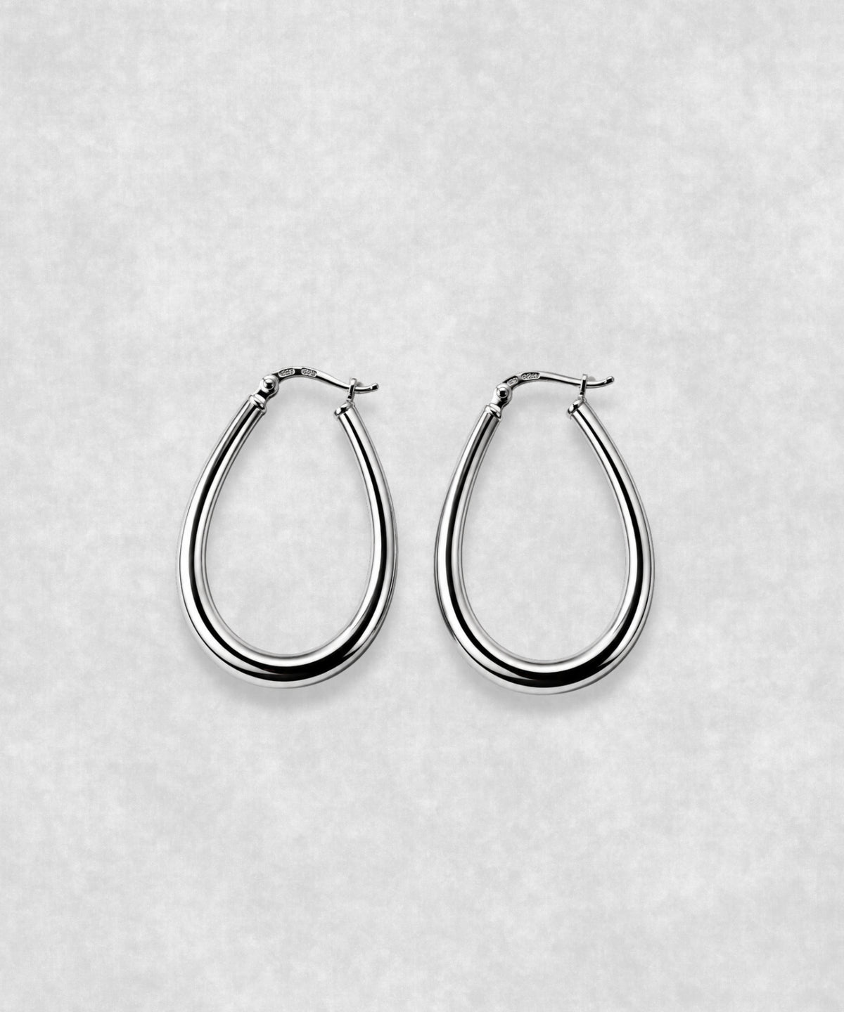 Oval hoop earrings in 925 sterling silver – polished sculptural silver earrings with contemporary minimalist design