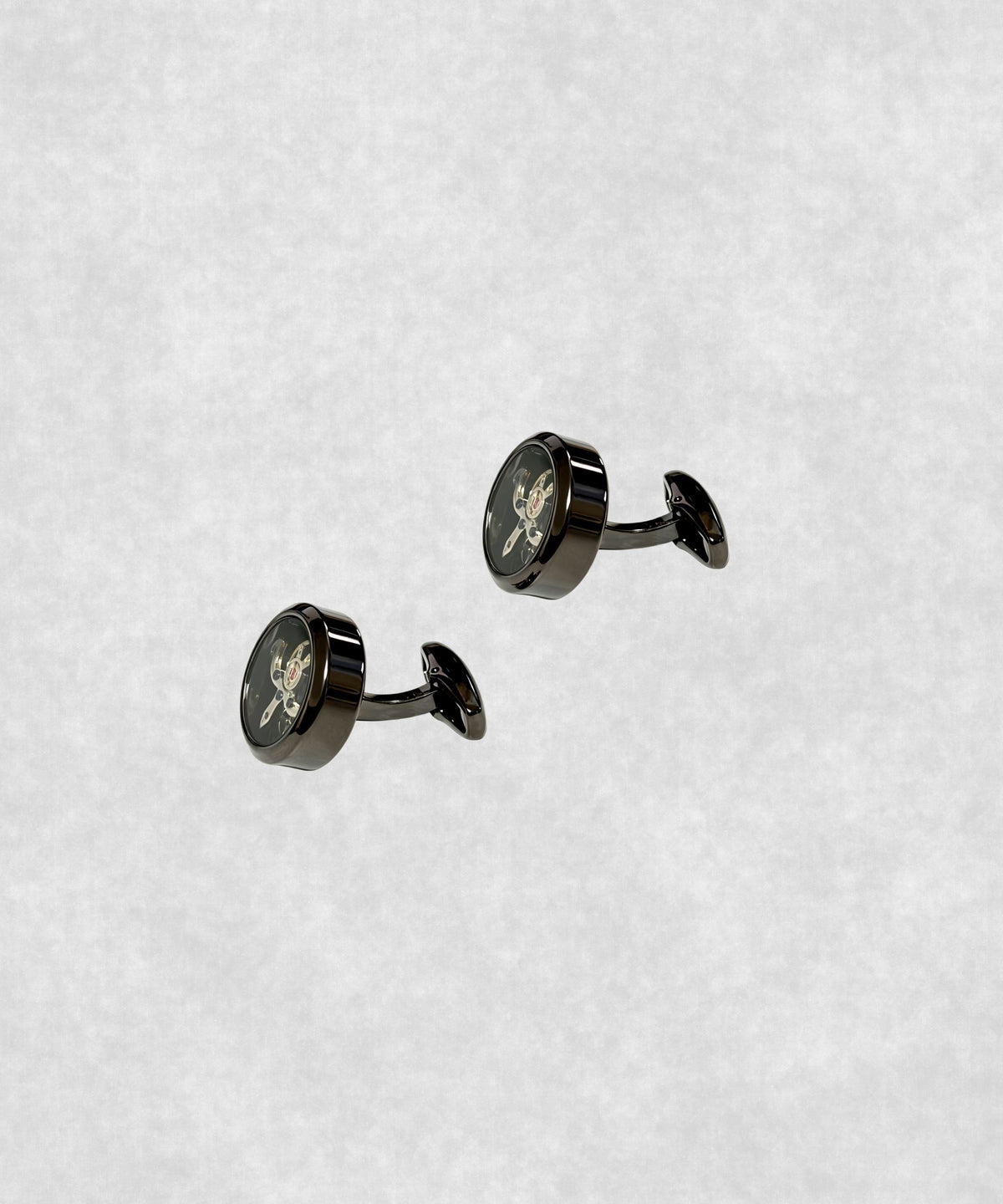 Side view of black-coated tourbillon cufflinks – luxury watch-inspired design with moving flywheel and blue screw details