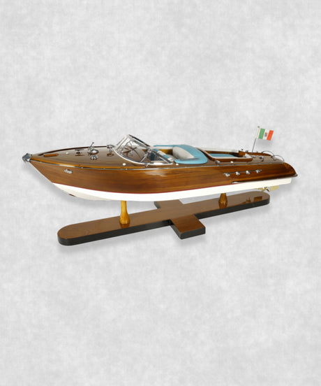 Handcrafted Riva speedboat model featuring polished wood and blue leather seats