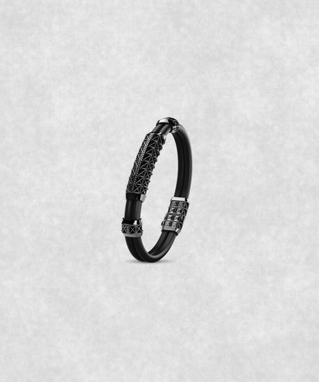 White gold-coated bracelet featuring a large centerpiece set with 37 diamonds and a flexible black rubber band.