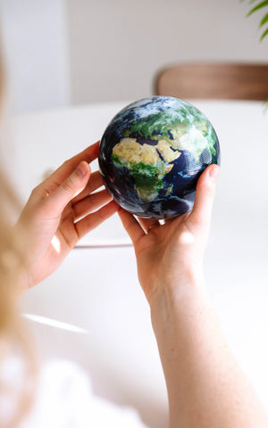 EARTH GLOBE ROTATING ON HANDS