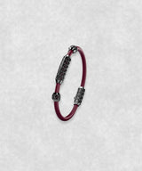 White gold-coated bracelet featuring a medium centerpiece set with 29 diamonds and a flexible bordeaux rubber band.