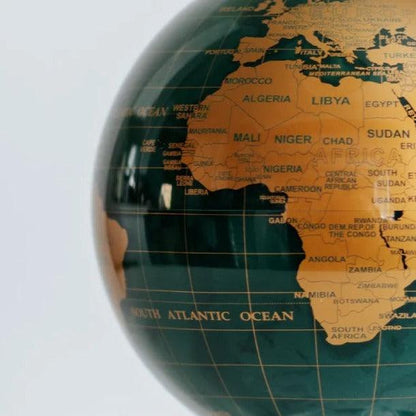 Close-up of MOVA Emerald Gold Political Map Globe – green self-rotating globe with detailed gold countries and borders