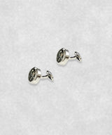 Side view of chrome-plated tourbillon cufflinks – luxury watch-inspired design with moving flywheel and blue screw details