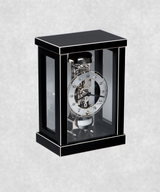 Front view of 14-day mechanical clock with black-painted natural wood frame – exposed movement, pendulum and hourly bell chime