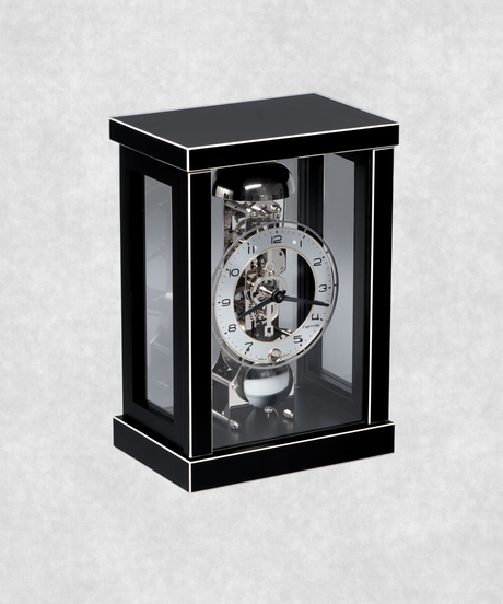 Front view of 14-day mechanical clock with black-painted natural wood frame – exposed movement, pendulum and hourly bell chime